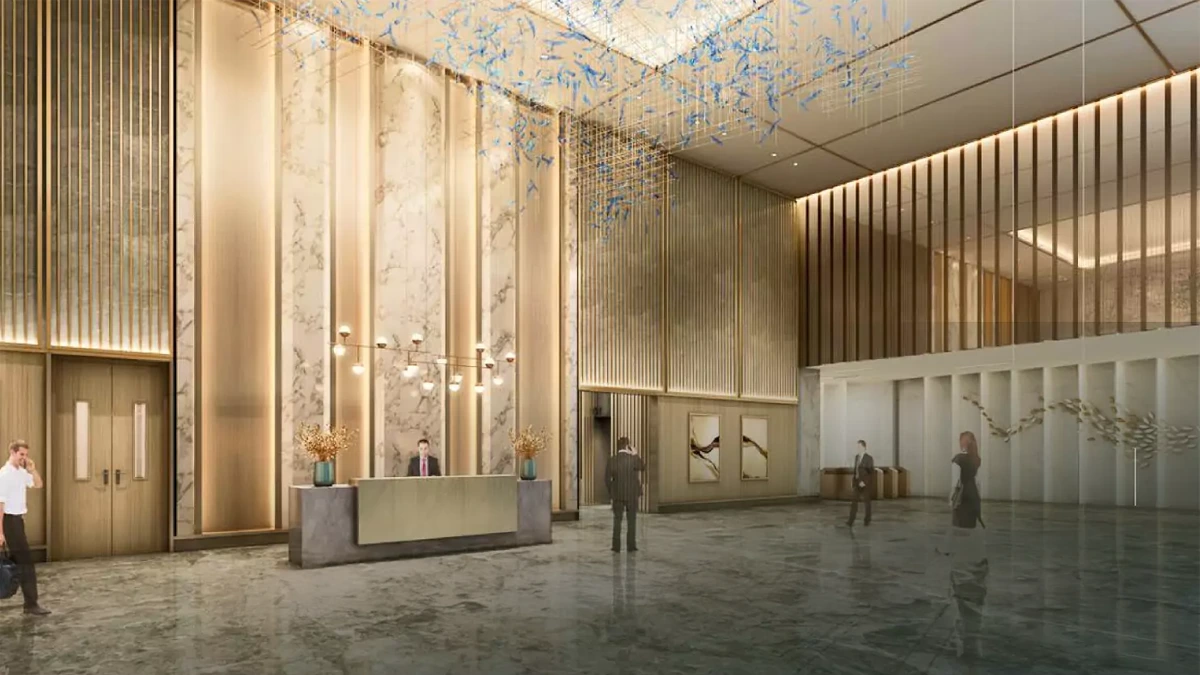 Modern and spacious lobby of Ganaga Anantam building with marble floors, reception desk, warm lighting, and people inside